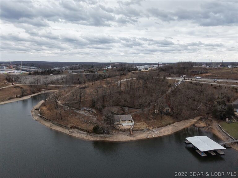 Prime lakefront acreage with fixer uppers